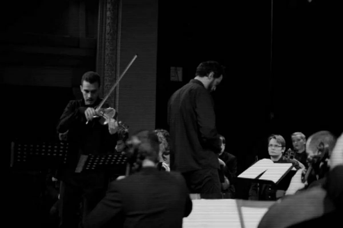 Igor Pejović with his violin in front of the Montenegro Youth Orchestra, playing Nocturno at Zetski dom, 2020