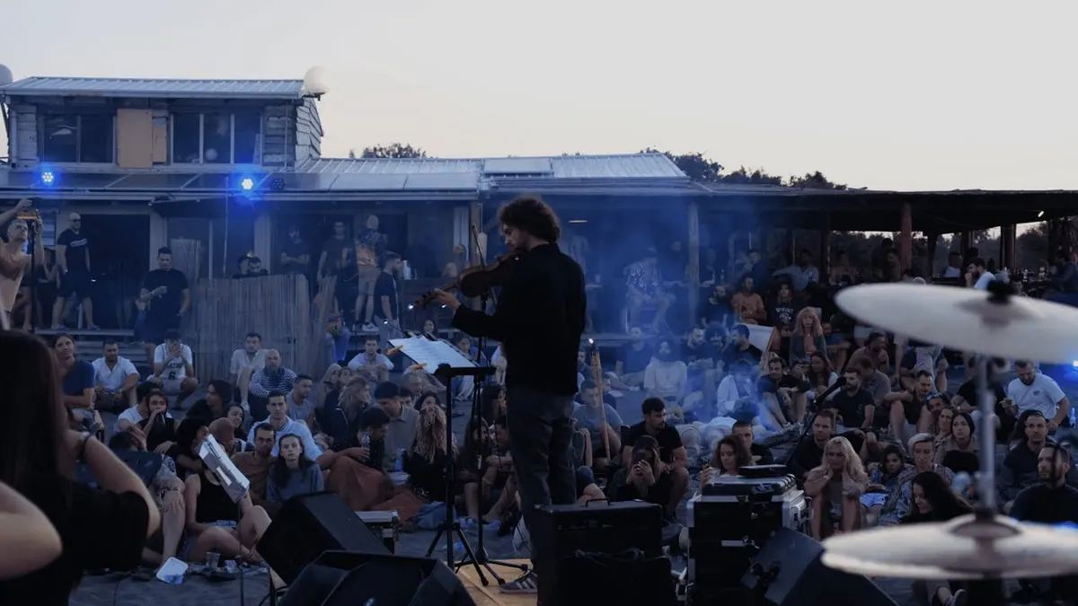 The orchestra playing on the beach in Ulcinj at dawn, the audience seated around