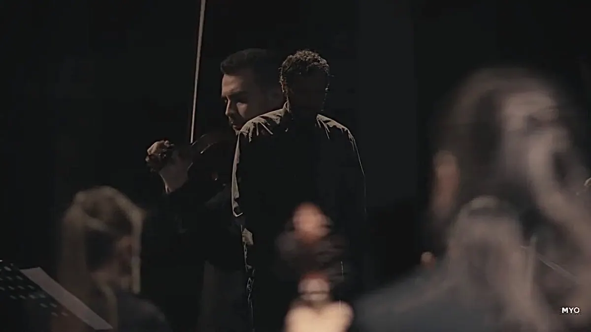 Igor Pejović with his violin in half-light, a still from the Nocturno video